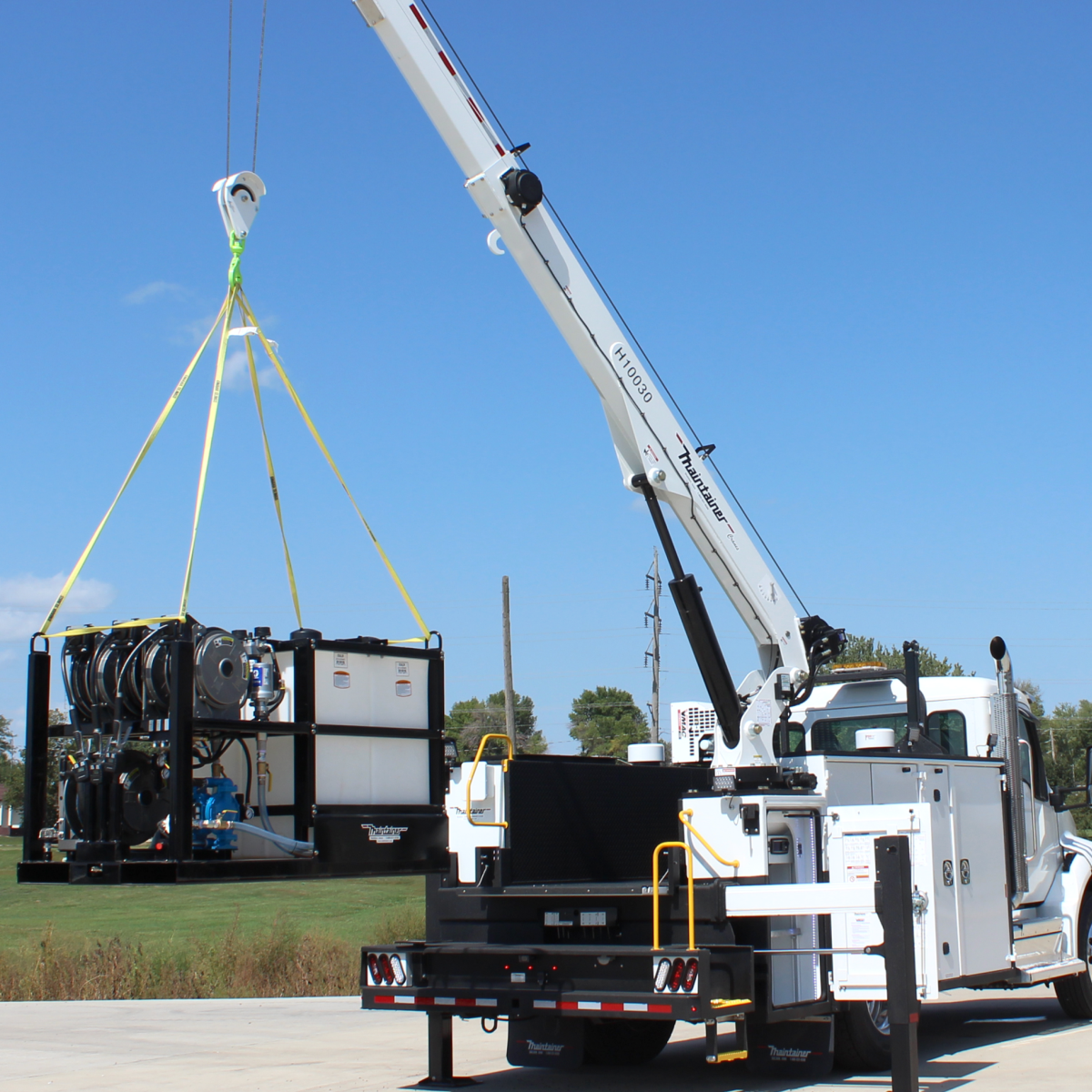 White crane truck lifting a lube skid