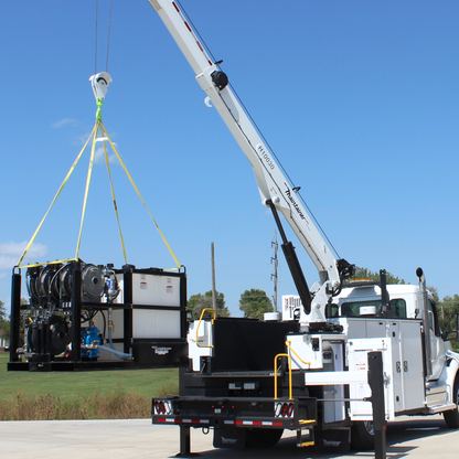White crane truck lifting a lube skid