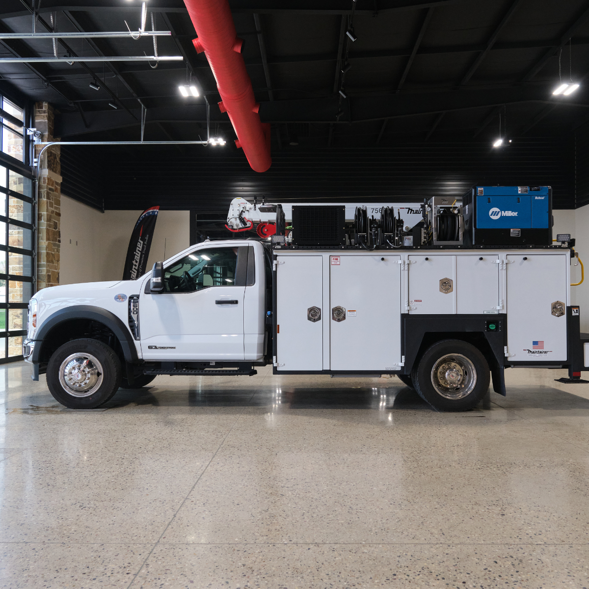 White utility truck with equipment in a showroom setting